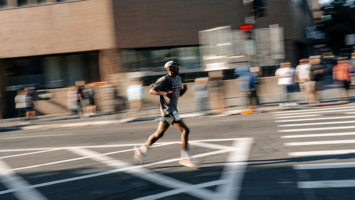 Runner in motion on a city street during a road race