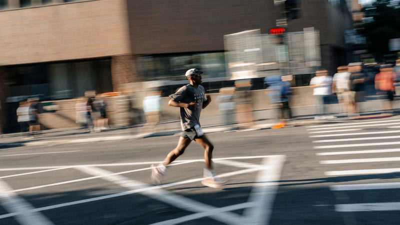 Runner in motion on a city street during a road race