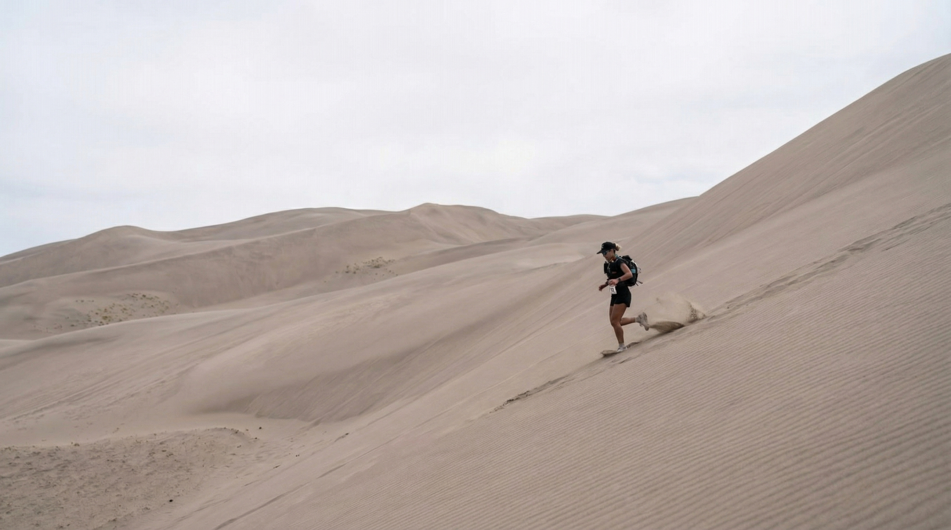 Trail running drop bag contents laid out on a wooden surface at dawn